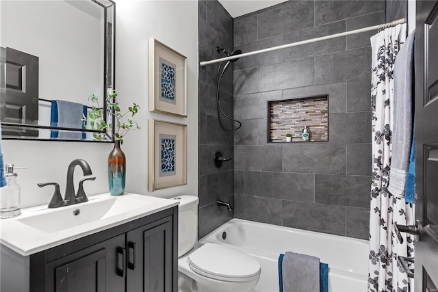 bathroom featuring toilet, shower / tub combo, and vanity