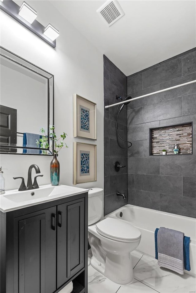 full bath with marble finish floor, bathtub / shower combination, visible vents, toilet, and vanity