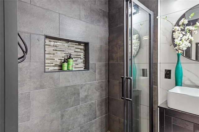 bathroom with a sink and a shower stall