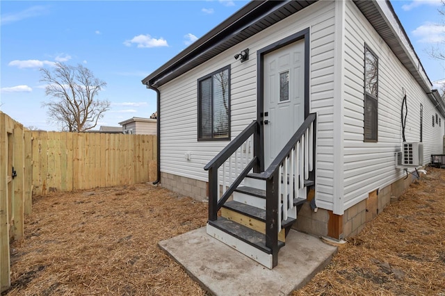 exterior space with crawl space, ac unit, and fence