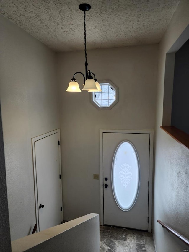 entryway with stone finish flooring and a textured ceiling