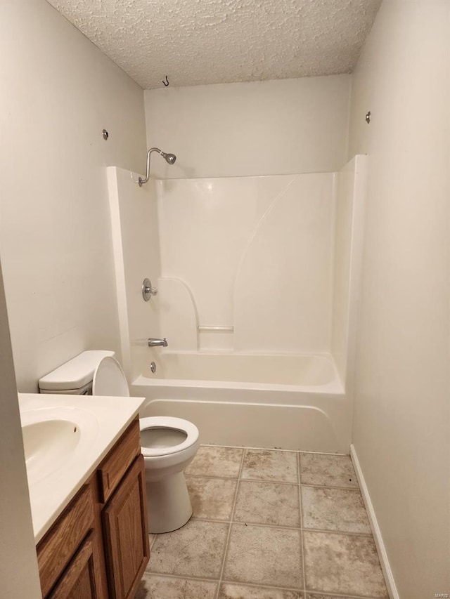 full bathroom with shower / tub combination, tile patterned floors, toilet, a textured ceiling, and vanity