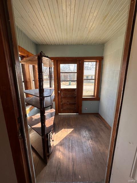 doorway to outside featuring hardwood / wood-style floors and wood ceiling