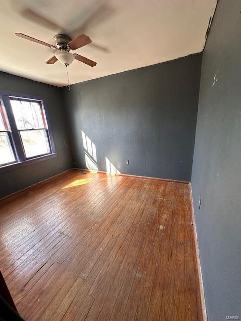 spare room with a ceiling fan and wood-type flooring