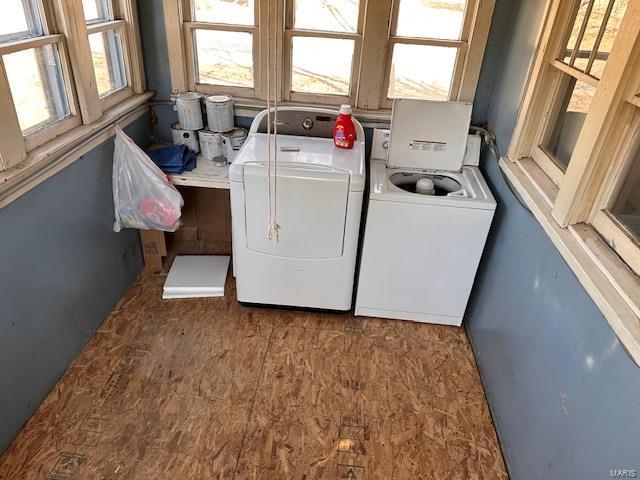 laundry room featuring laundry area, separate washer and dryer, and wood finished floors