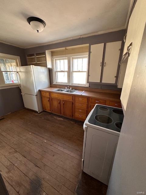 kitchen with white appliances, white cabinets, brown cabinets, dark wood-type flooring, and a sink