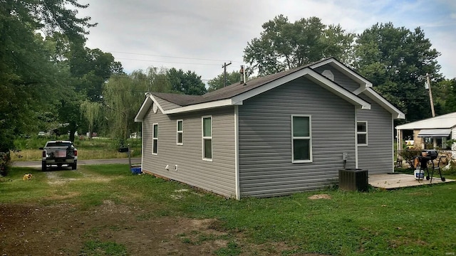 view of home's exterior with a yard and central air condition unit