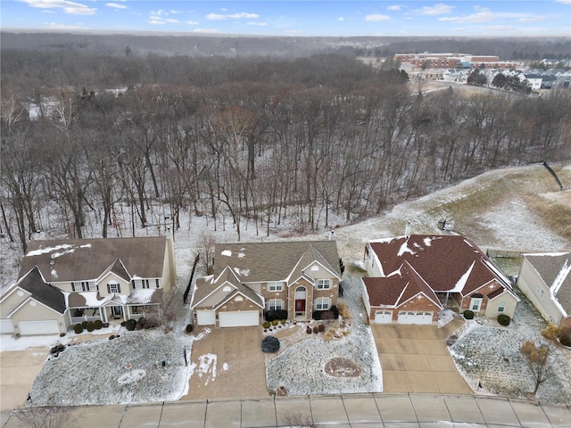 snowy aerial view with a residential view