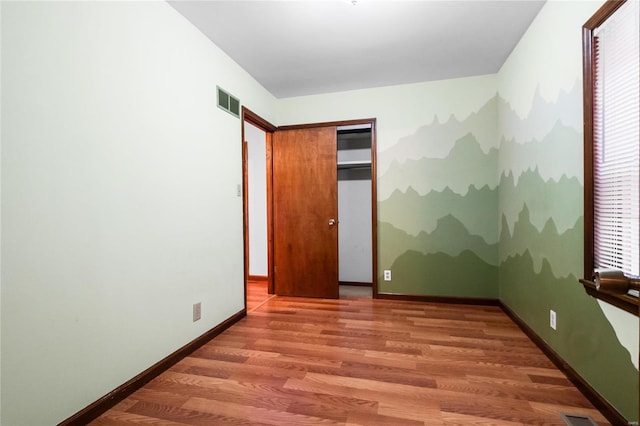 unfurnished bedroom with hardwood / wood-style flooring