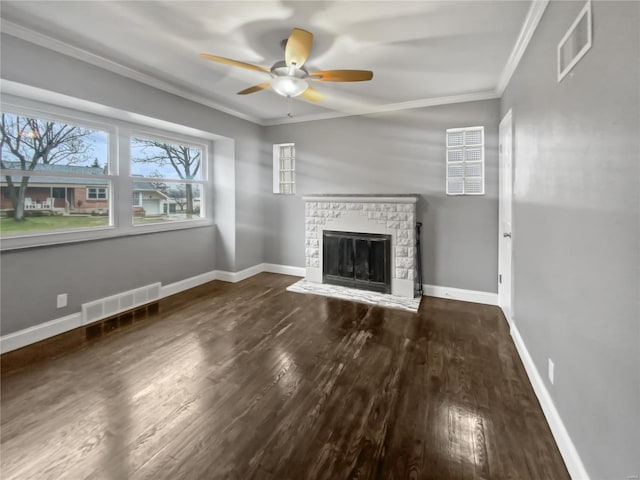 unfurnished living room featuring a fireplace with raised hearth, visible vents, dark wood finished floors, and crown molding