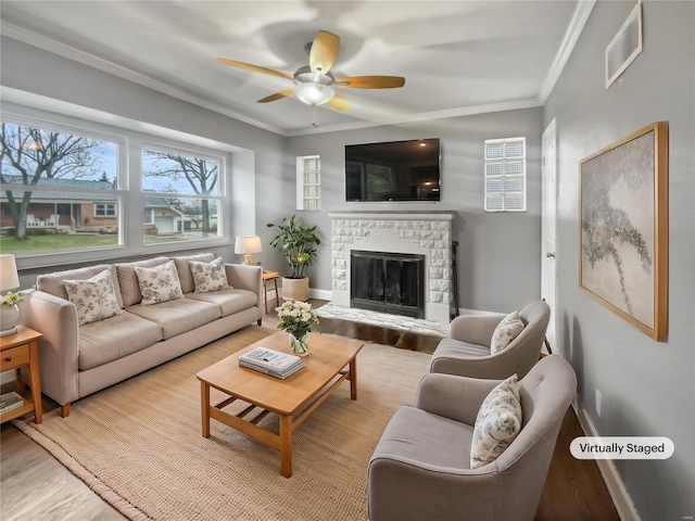 living room with light wood-type flooring, visible vents, and crown molding