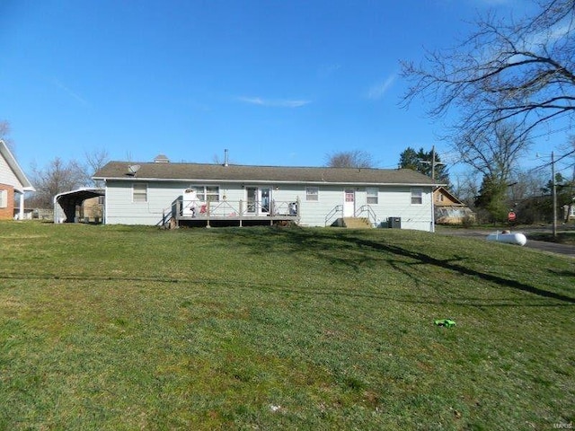 exterior space featuring a wooden deck, a carport, and a lawn