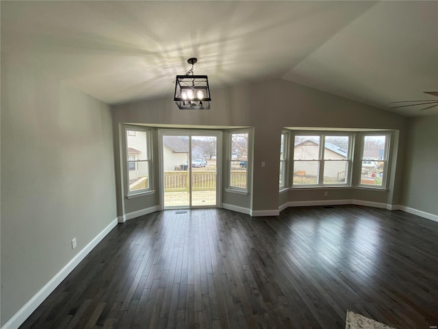 interior space featuring vaulted ceiling, dark wood-style flooring, and a wealth of natural light