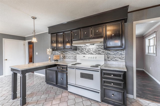 kitchen with white range with electric cooktop, light countertops, crown molding, under cabinet range hood, and backsplash