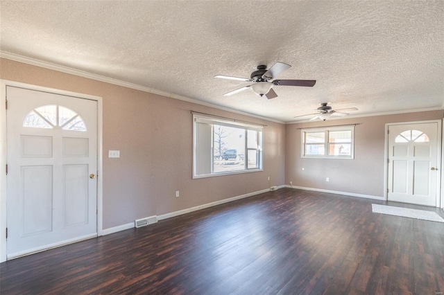 foyer featuring ornamental molding, dark wood-style flooring, visible vents, and baseboards