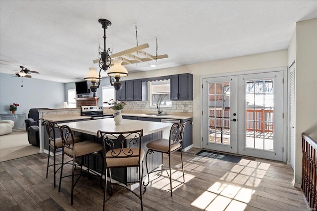 dining space featuring french doors, dark wood finished floors, a textured ceiling, and baseboards