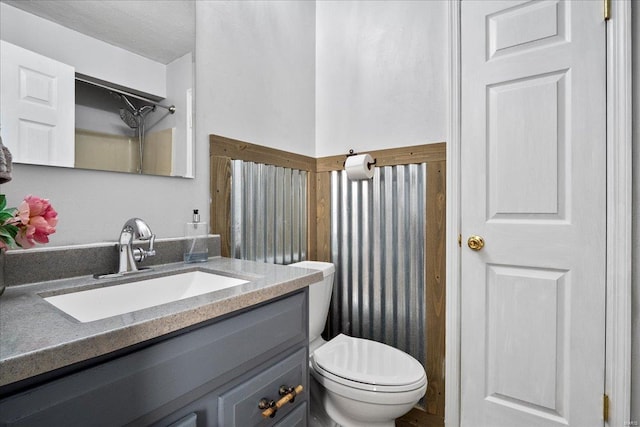 bathroom with toilet and vanity