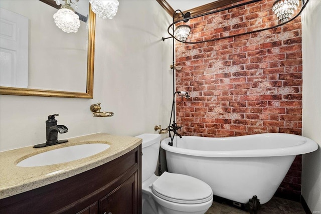 bathroom featuring toilet, a freestanding tub, brick wall, and vanity