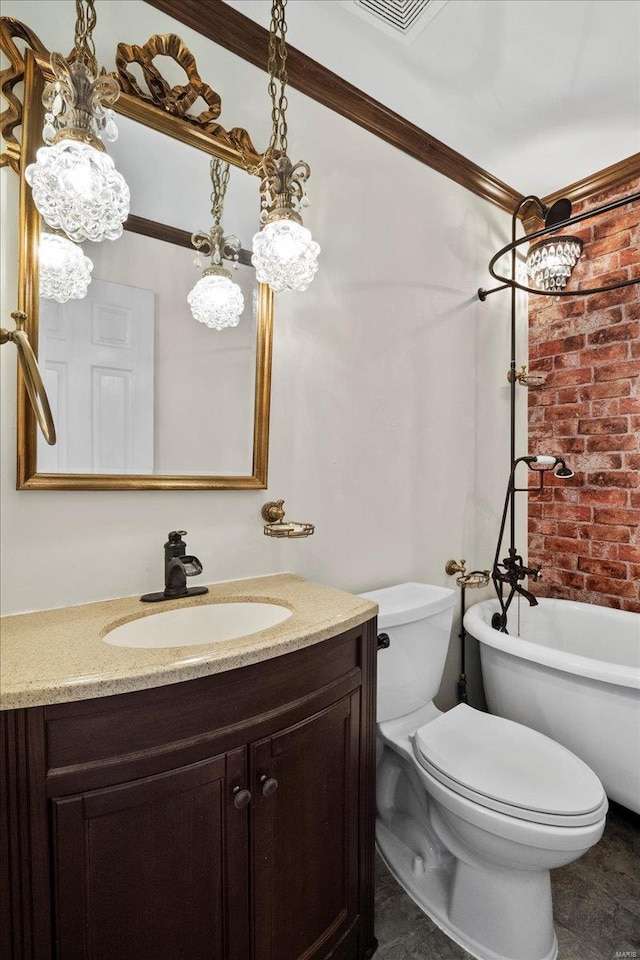 bathroom with a freestanding bath, vanity, and toilet