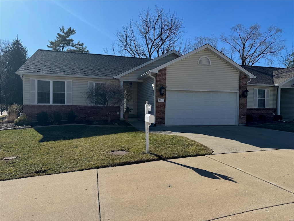 ranch-style house with a front yard, brick siding, driveway, and an attached garage