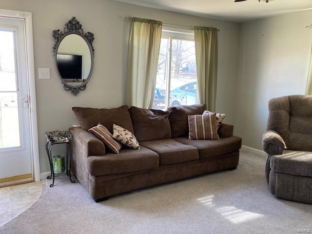 living room featuring carpet, a ceiling fan, and baseboards