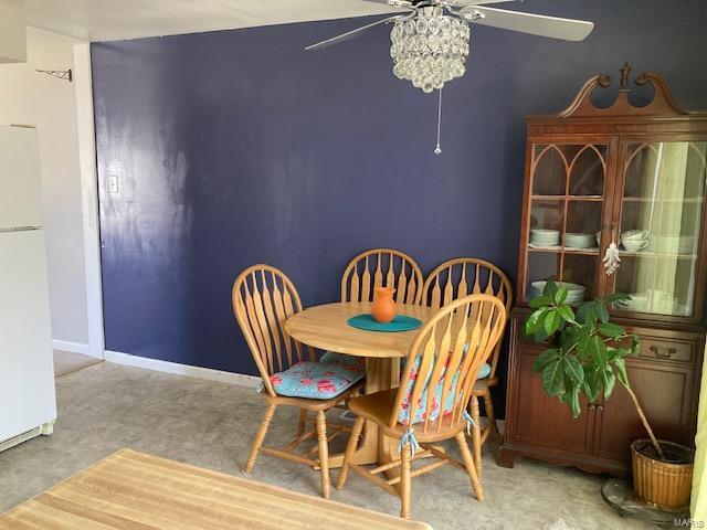 dining area featuring ceiling fan and baseboards