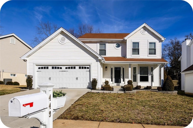 traditional home with covered porch, driveway, a front yard, and an attached garage