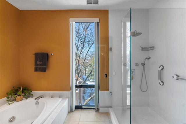 full bathroom featuring a garden tub, a walk in shower, visible vents, and tile patterned floors