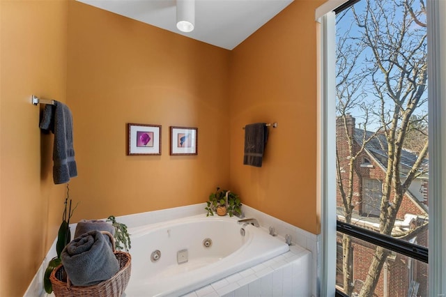 bathroom featuring a jetted tub and a healthy amount of sunlight