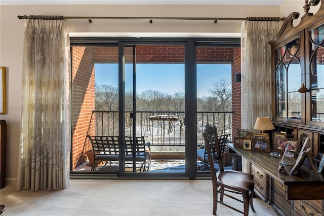 doorway featuring plenty of natural light and carpet