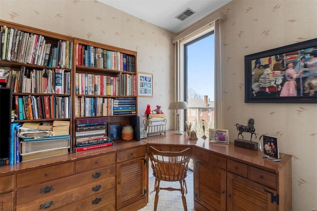 home office with visible vents and wallpapered walls