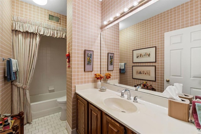 full bath with tile patterned flooring, toilet, vanity, and shower / bathtub combination