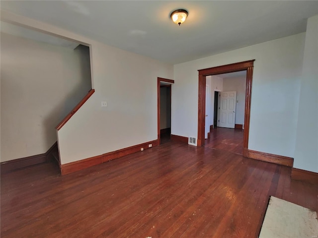 unfurnished room with dark hardwood / wood-style floors