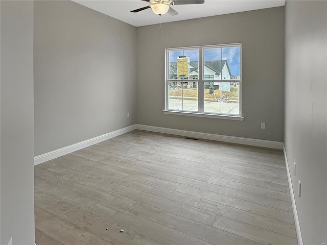 empty room featuring light wood-type flooring and ceiling fan