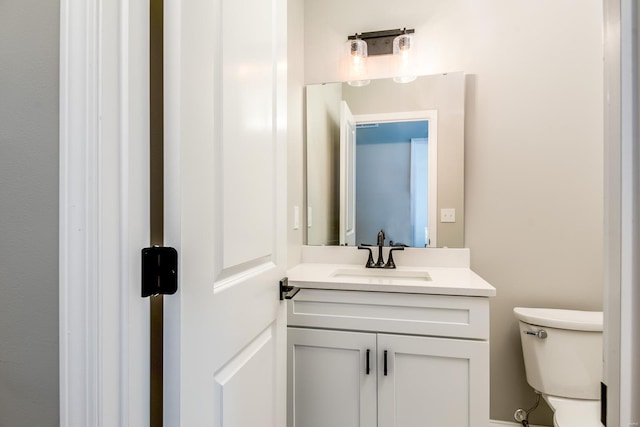 bathroom with toilet and vanity