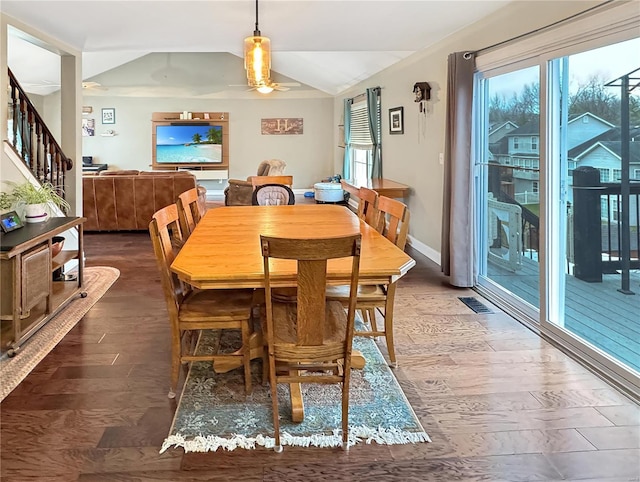 dining space with lofted ceiling, dark hardwood / wood-style floors, and ceiling fan