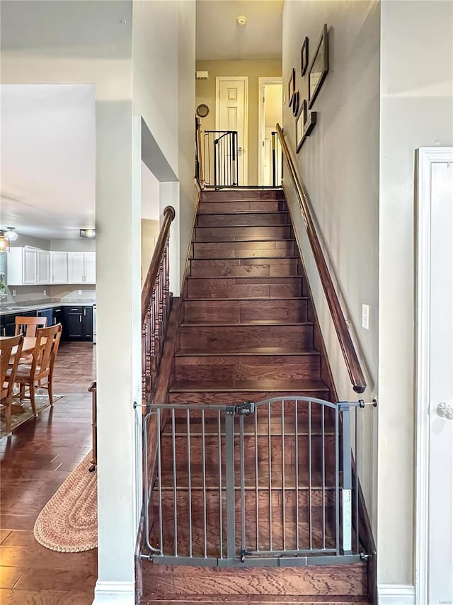 staircase with wood-type flooring