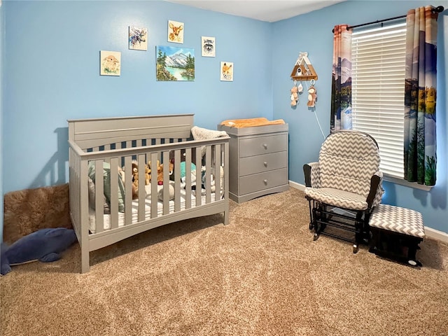 bedroom with a crib and light carpet