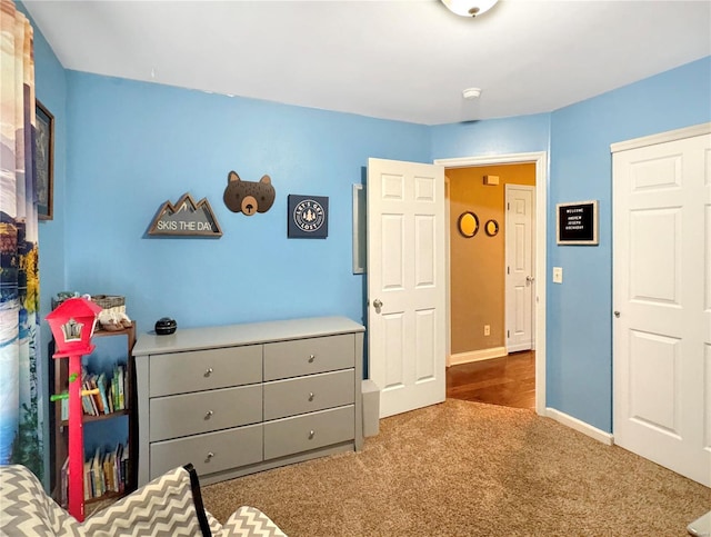 bedroom featuring dark carpet