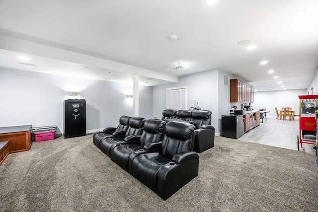 home theater room with light colored carpet