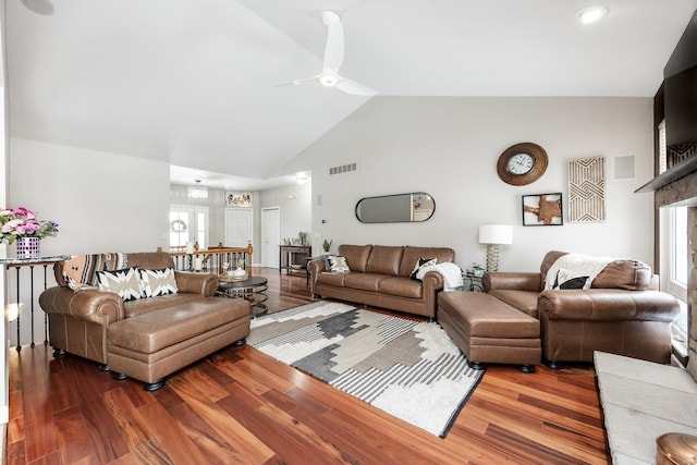 living room with high vaulted ceiling, hardwood / wood-style flooring, and ceiling fan