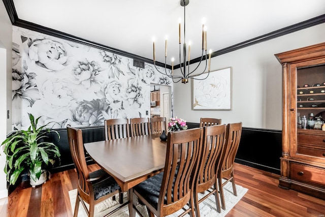 dining space featuring a chandelier, crown molding, and dark hardwood / wood-style floors