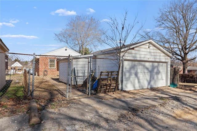 view of outbuilding with a garage, an outbuilding, and fence