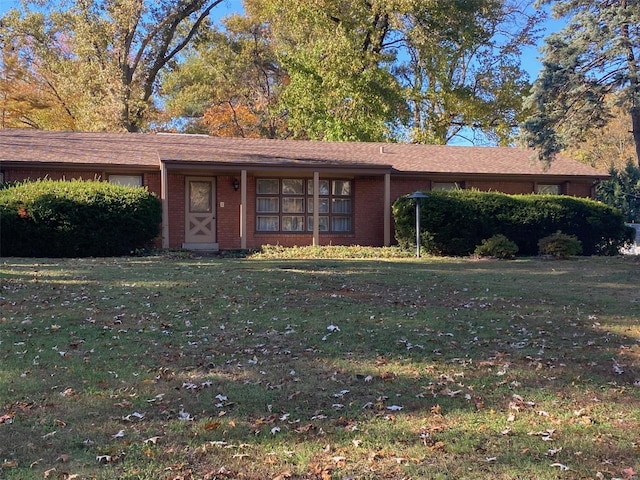 ranch-style house with brick siding and a front yard