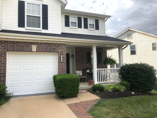 view of front of house featuring covered porch and a garage