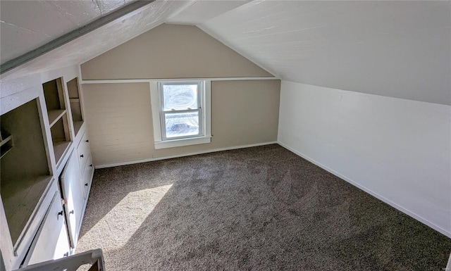 bonus room featuring carpet floors, baseboards, and vaulted ceiling