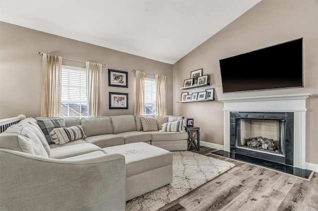 living room with lofted ceiling and hardwood / wood-style flooring