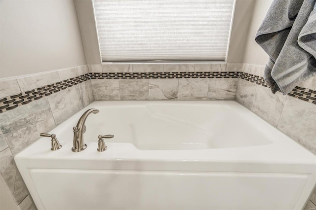 bathroom with a tub to relax in