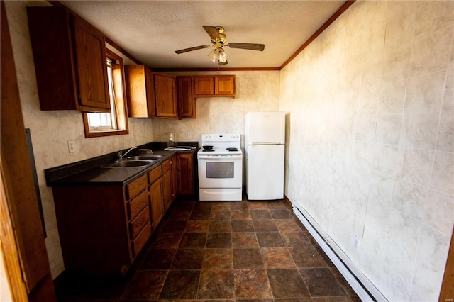 kitchen featuring a sink, dark countertops, a baseboard heating unit, white appliances, and brown cabinetry