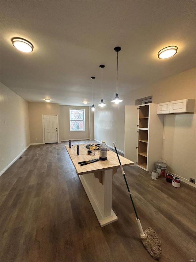 interior space with dark wood-style floors and baseboards